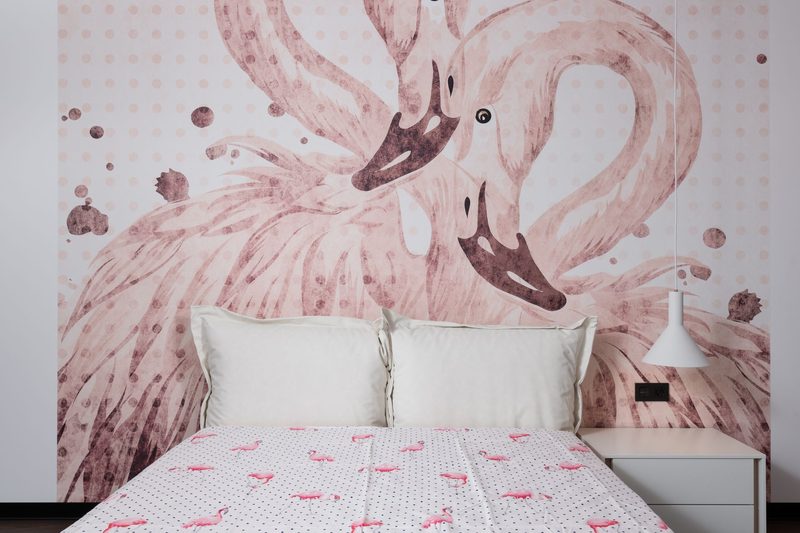 Bedroom with a large pink flamingo mural feature wall