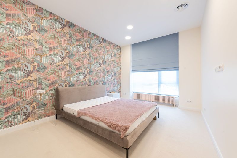 Bedroom with a geometric earth-toned feature wall
