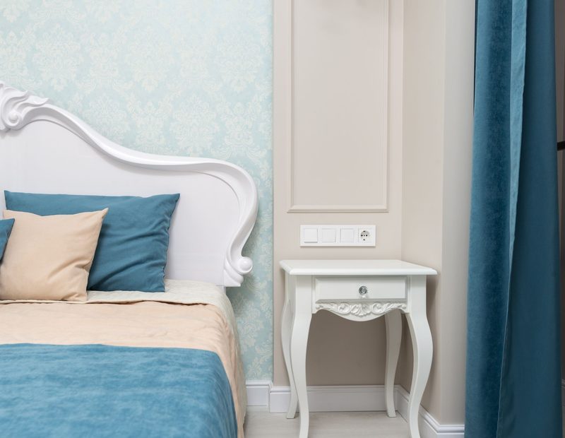 Soft grey damask bedroom wall with teal accents